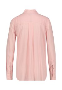 Light pink long-sleeve shirt with thin white stripes, button cuffs, and a collar. Features a straight back yoke and a relaxed fit.