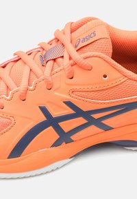 Orange athletic shoe with mesh and synthetic material, featuring blue accents, laces, and a textured pattern on the upper.