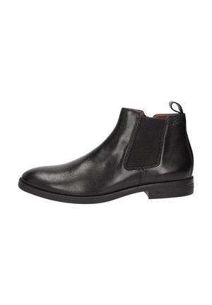 Bottine Chelsea en cuir noir avec panneau élastique sur les côtés, petit talon et languette à l'arrière pour un enfilage facile.
