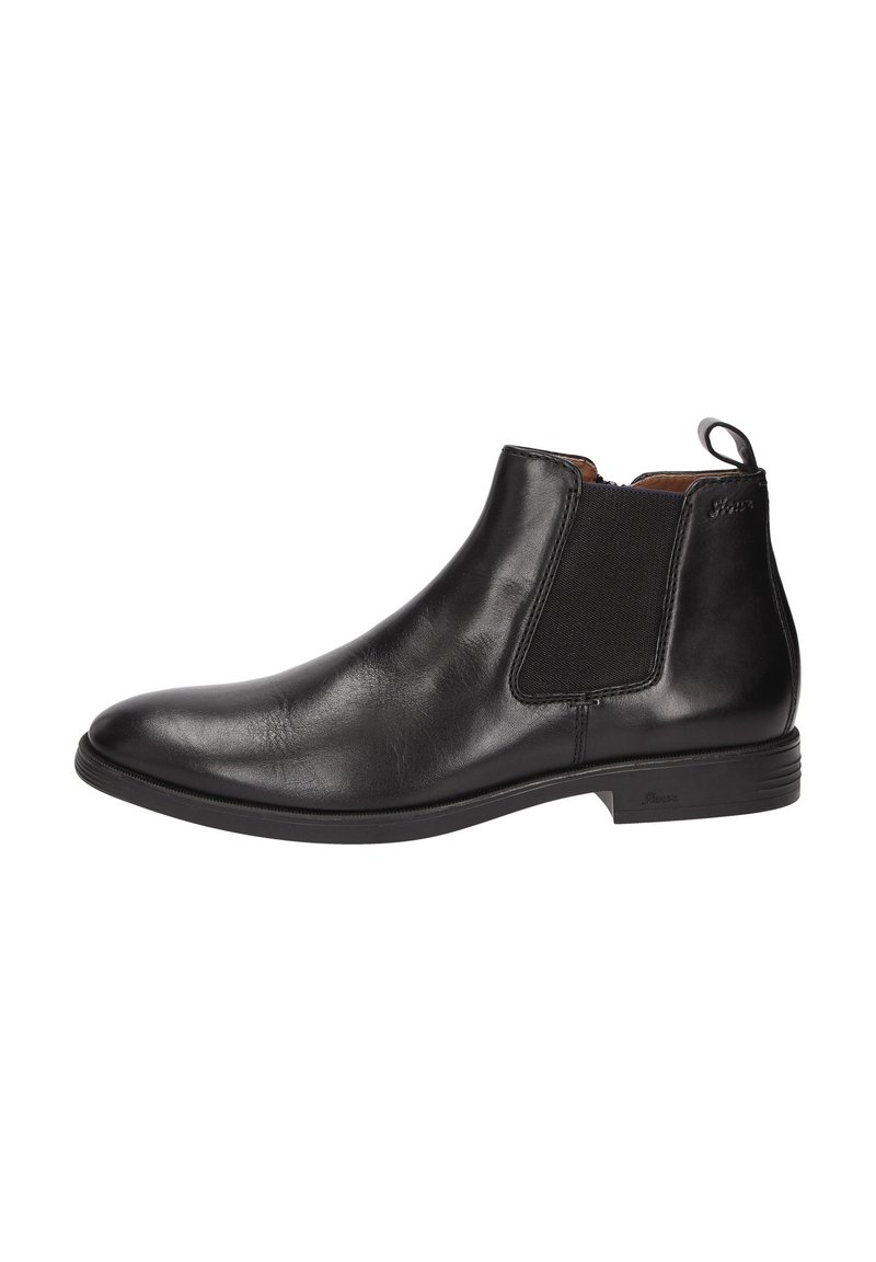 Bottine Chelsea en cuir noir avec panneau élastique sur les côtés, petit talon et languette à l'arrière pour un enfilage facile.
