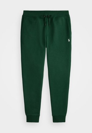 Groene sweats met een zachte stof, voorzien van een trekkoord in de taille, geborduurde enkels en een klein geborduurd logo op de linkerdij.