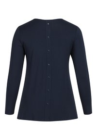 Námornícky top s dlhým rukávom vyrobený z mäkkého materiálu, s krátkym výstrihom, zipsom na chrbte a voľným strihom.