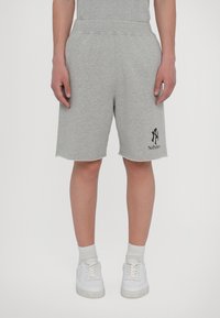 Gray sweat shorts made of cotton blend with an elastic waistband, side pockets, and a raw hem. Features a black logo graphic.