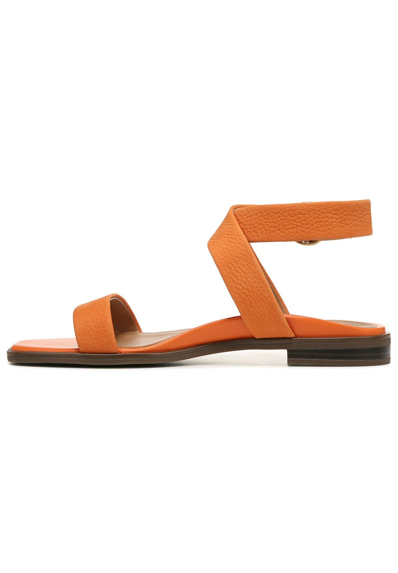 Orange leather sandal with a flat sole, featuring wide bands across the foot and an ankle strap with a textured finish.