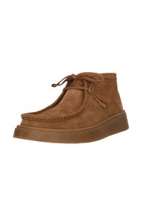Brown suede ankle boots with rounded toe, stitched detailing, and rubber sole. Features laces and a fabric tag on the side.