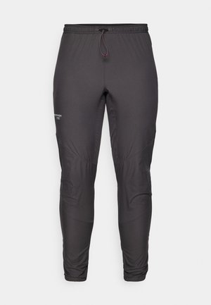 Black athletic pants with an elastic waistband, drawstring, and knee panels for flexibility; smooth texture, and no visible patterns or accents.