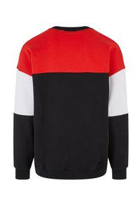 Fargeblokkert sweatshirt med seksjoner i rød, svart og hvit, rund hals og lange ermer. Laget av myk, strukturert bomull.