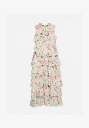 Robe maxi sans manches à étages avec motif floral rose, feuilles vertes et nœud au col sur fond beige clair.