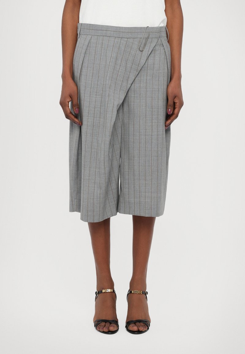 Gray pinstripe culottes with a paperclip accent, featuring a tailored waistband and a relaxed fit, paired with black strappy sandals.