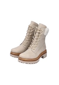 Bottes en suède beige à lacets avec côtés texturés, col orné de fourrure et semelle en caoutchouc robuste. Comprend des œillets en ton doré et des détails de couture.
