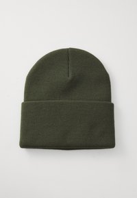 Knit beanie in dark green. Features a snug fit, fold-over cuff, and smooth texture. No visible patterns or embellishments.