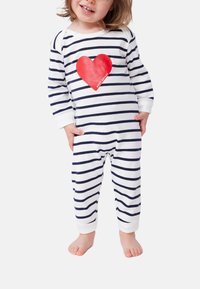 Κορμάκι με ρίγες σε μπλε ναυτικό και λευκό, με μεγάλο κόκκινο σχέδιο καρδιάς στο μπροστινό μέρος και μαλακό, ελαστικό ύφασμα με μακριά μανίκια.
