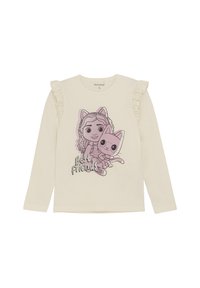 Langärmliges cremefarbenes T-Shirt mit Rüschendetails an den Schultern, versehen mit einer Grafik eines Cartoongirls und einer Katze mit dem Text "Beste Freunde."