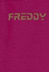 Testo "FREDDY" marrone con texture su uno sfondo di tessuto magenta uniforme.