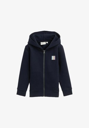 Felpa con zip navy in morbido misto cotone, con tasca frontale, polsini a costine e un logo quadrato con faccina sorridente sul lato sinistro del petto.