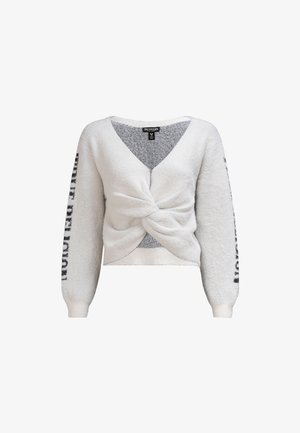 Pull blanc, fluffy, à manches longues avec un design croisé à l'avant, col en V et lettrage noir sur les manches. Texture douce et coupe courte.