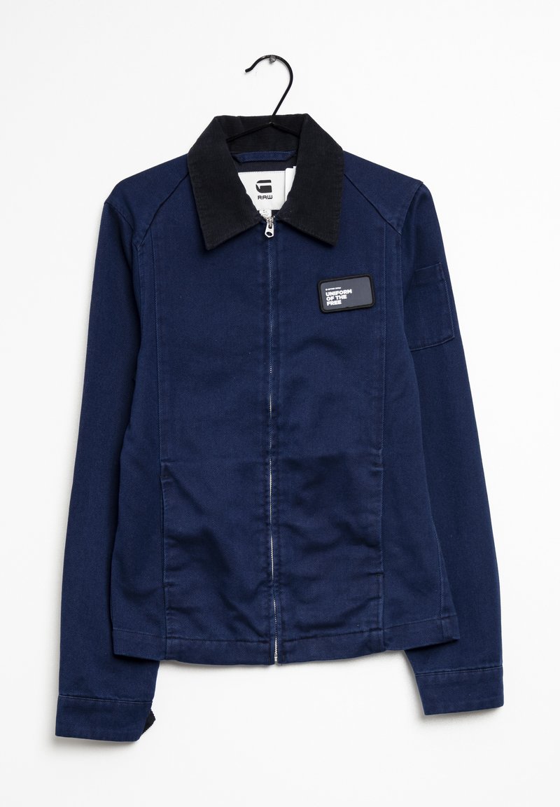 Navy blue jacket made of denim with a corduroy collar, front zipper, and a rectangular patch labeled "UNIFORM OF THE PREY."