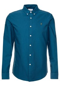 Camisa de algodón color verde azulado, con cuello clásico, mangas largas, botones blancos y un pequeño logo dorado en el pecho izquierdo.