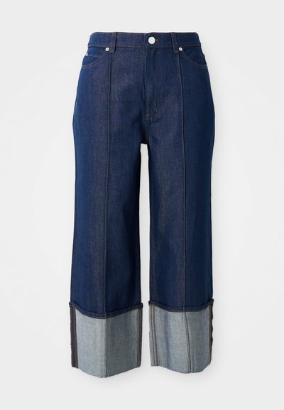 Dark blue wide-leg jeans with folded cuffs showing lighter denim inside, front button, and pockets on a white background.