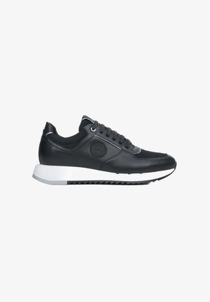 Black sneaker made of leather and mesh, featuring a white sole, round toe, and flat laces. Accented with a circular logo on the side.