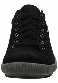 Black suede sneaker with metal eyelets, flat laces, rubber textured sole, and a rounded toe. Minimalist design with a sleek profile.
