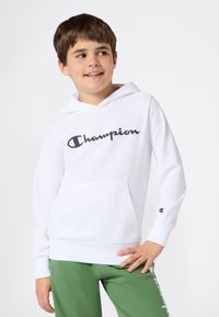 Felpa con cappuccio bianca con un grande logo nero "Champion" sul davanti, presenta una tasca a marsupio, cappuccio con coulisse e polsini a costine.