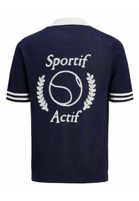 Navy blue short-sleeve polo shirt with white collar, featuring 'Sportif Actif' text and a tennis ball graphic, accented by striped sleeves.