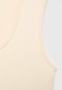 Beige tank top with a smooth, stretchy fabric. Features wide shoulder straps and a rounded neckline, suitable for layering or casual wear.