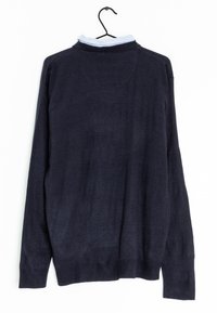 Navy blue knit sweater with long sleeves, featuring a light blue collared shirt underneath. Smooth texture and ribbed cuffs at the hem.