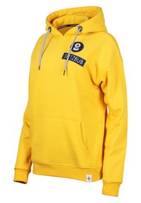 Yellow cotton hoodie with a front pocket, drawstrings, and black logo patch. Features ribbed cuffs and hem. Smooth, soft texture.