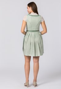 Green patterned dress with pleats, adjustable waist tie, and lace short-sleeve top. Smooth fabric with a subtle design and back detail.