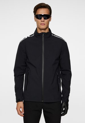 Black zip-up jacket with high collar, featuring white stripes on shoulders, side zip pockets, textured fabric, and adjustable cuffs.