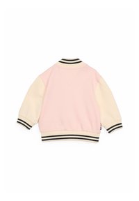 Ljusrosa sweatshirt med cremefärgade ärmar, som har svart och elfenbensfärgad randig ribbkrage och manschetter, samt en enkel bakdesign.