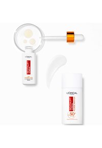 Sérum Revitalift de L'Oréal dans un flacon blanc avec du texte rouge et un pipette. Une crème solaire blanche avec un texte rouge/noir. Texture crémeuse blanche visible.