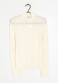 Crème lange mouw shirt met een hoge halslijn, gemaakt van lichte, iets doorzichtige stof. Heeft een rechte snit en een zijsplit aan de zoom.