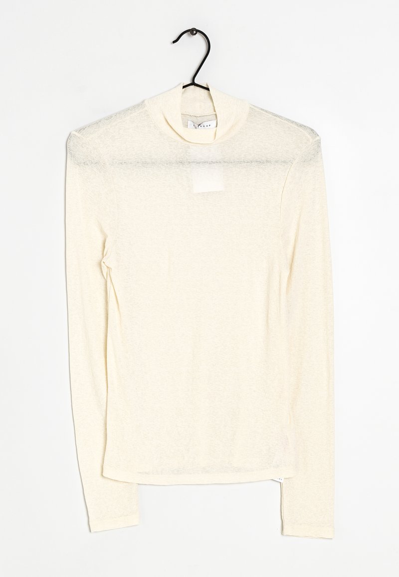 Crème lange mouw shirt met een hoge halslijn, gemaakt van lichte, iets doorzichtige stof. Heeft een rechte snit en een zijsplit aan de zoom.