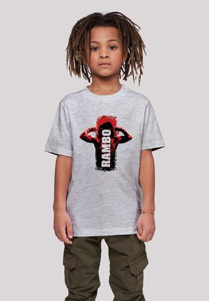 Gray cotton T-shirt featuring a bold black and red graphic of a flexing figure and the word "RAMBO" in black text, relaxed fit, and short sleeves.