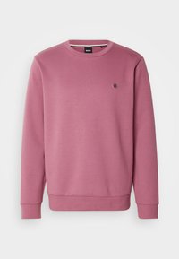 Sweat-shirt mauve à manches longues avec col rond, poignets et ourlet côtelés, avec un petit logo rond sur la poitrine gauche.