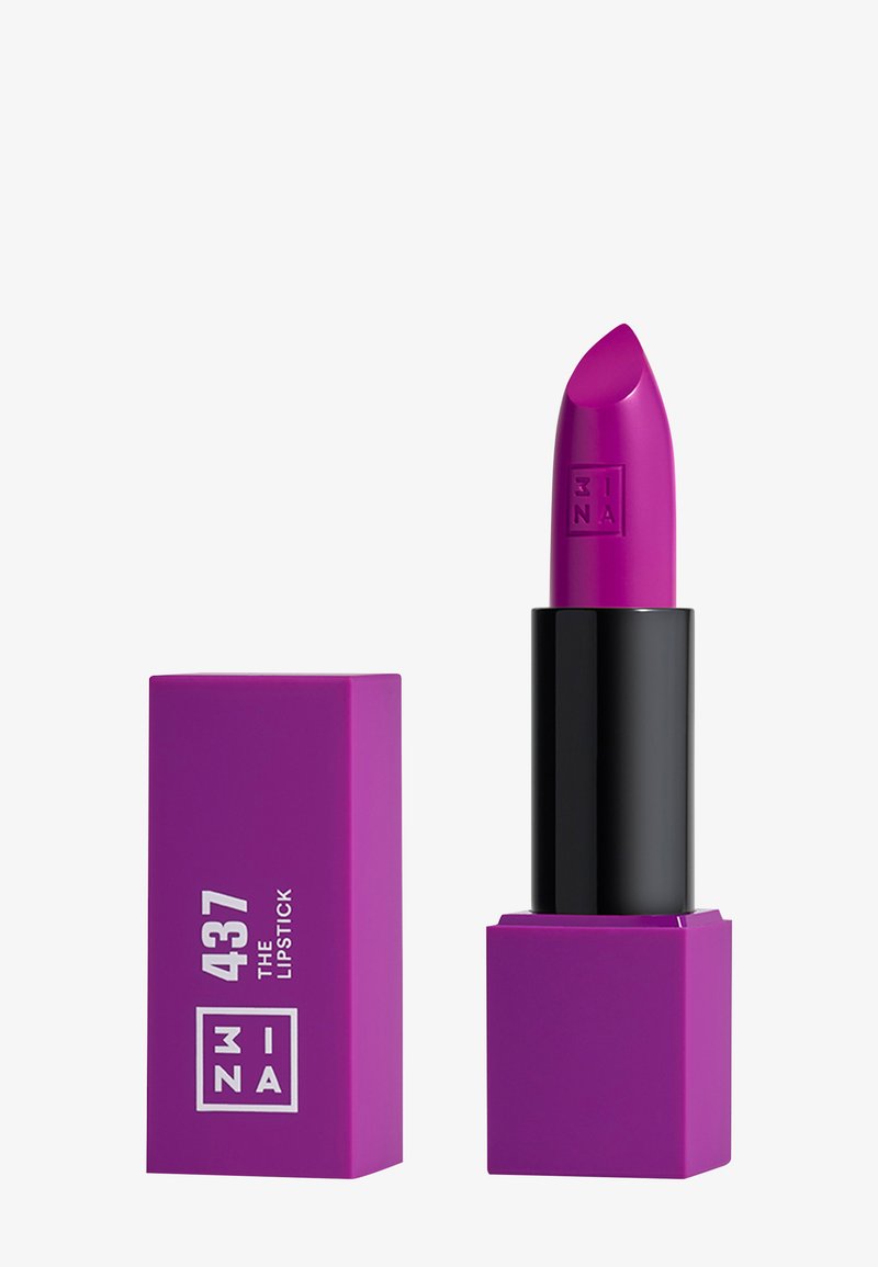Rouge à lèvres magenta vif dans un tube noir et violet élégant. Présente une base carrée et un logo en relief. La mine a une pointe lisse et effilée.