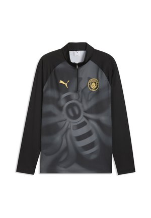 Haut de sport Puma noir et gris à manches longues avec logo Manchester City et grand motif stylisé d'abeille sur le devant.