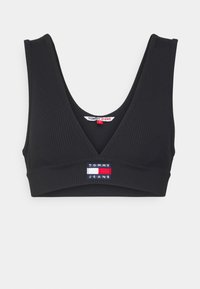 Svart ribbad bralette med V-hals, breda axelband och en sydd logotyp i röd, vit och blå färg i mitten.