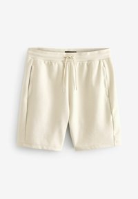 Shorts en coton beige avec une taille élastique, cordon de serrage et poches latérales ; texture lisse, design à mi-cuisses et style minimaliste.