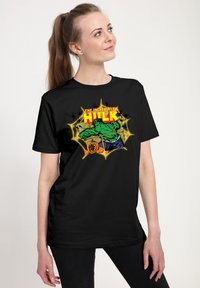 Černé bavlněné tričko s barevným grafikou "Neuvěřitelný Hulk" s zelenou postavou, žlutým textem a akcenty v komiksovém stylu.