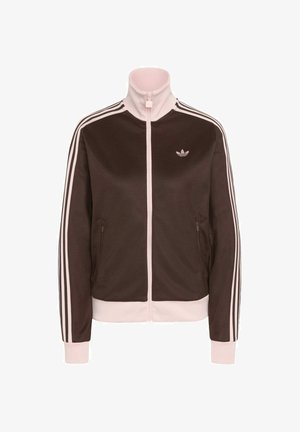 Braune und hellrosa Adidas Trainingsjacke mit durchgehendem Reißverschluss, hohem Kragen, drei Streifen an den Ärmeln und Logo auf der linken Brust.
