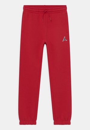 Rote Jogginghose mit elastischem Bund, Kordelzug, seitlichen Taschen, elastischen Bündchen und einem kleinen schwarz-weißen Jumpman-Logo am rechten Oberschenkel.