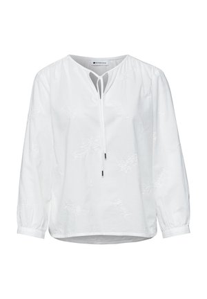 Hvid bluse med lange ærmer med diskret blomsterbroderi, nøglehulshalsudskæring og bindebånd foran, med opsamlede manchetter og en let rundet kant.