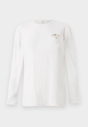 White long-sleeve shirt with small brown mountain graphic and "Paradise Tour" text on the left chest.