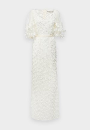 White dress with floral texture, V-neck, and sheer puff sleeves. Satin belt at the waist. Floral appliqués on the fabric add dimension.