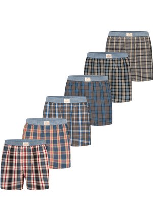 Six pairs of plaid men's boxer shorts in various blue, brown, and beige tones with blue elastic waistbands, arranged in a diagonal line.