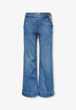 Siniset farkkuleleva lahkeita housuja, joissa nappieditykset kummallakin puolella vyötäröä, litteä etuosa ja ei näkyviä taskuja.